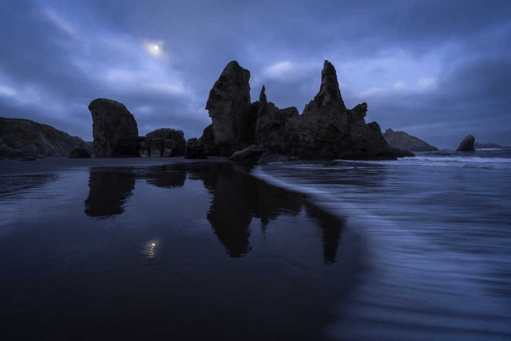 Full moon rises above the sea stacks of Bandon Beach